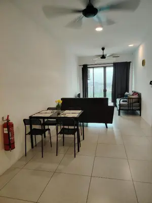 a living room with a table and chairs and a couch at Meritus Seaview Apartment in Perai