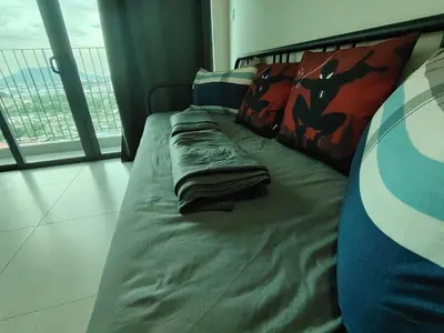 a bed in a hotel room with a bed sidx sidx sidx at Meritus Seaview Apartment in Perai