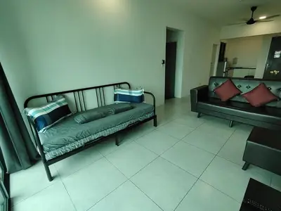 a living room with two beds and a couch at Meritus Seaview Apartment in Perai