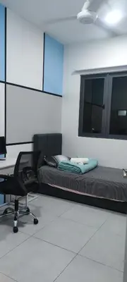 a room with a bed and a desk and a chair at Meritus Seaview Apartment in Perai