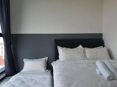 a bedroom with two beds with white sheets and pillows at Urban Suites Penang P2 LDL WL in Jelutong