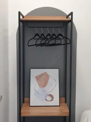 a shelf with a picture and a painting on it at Urban Suites Penang P2 LDL WL in Jelutong