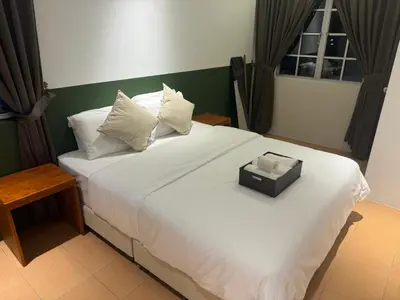 a large white bed with a box on it at Jambul Villa 3-storey corner House 6Bed5Bathroom in Bayan Lepas