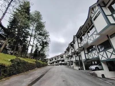 an empty street in front of an apartment complex at Highland Hideaway 1 Bedroom Apartment at Equatorial Hill Resort in Brinchang