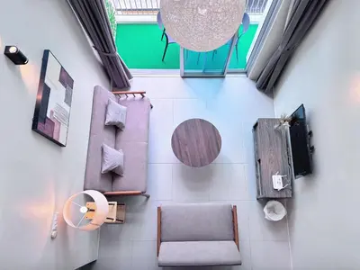 a room with a chair and a table at Penthouse with 3 bedrooms, Golden Hills Night Market in Brinchang