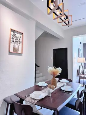 a dining room with a wooden table and chairs at Penthouse with 3 bedrooms, Golden Hills Night Market in Brinchang