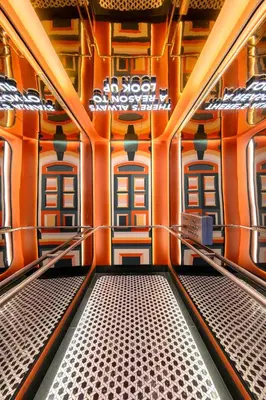 a corridor of a train with orange walls and windows at lyf Georgetown Penang in George Town