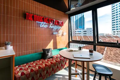 a restaurant with a table and a bench and a window at lyf Georgetown Penang in George Town