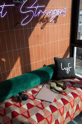 a room with a bed with a laptop and camera at lyf Georgetown Penang in George Town