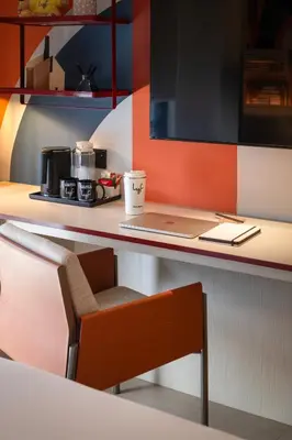 a desk with a laptop computer on a counter at lyf Georgetown Penang in George Town