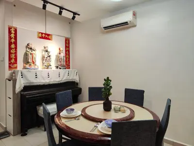 a dining room with a table and a piano at Lenggong GEM 16 Homestay in Kampong Ulu Jepai