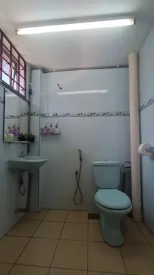 a bathroom with a blue toilet and a sink at Lenggong GEM 16 Homestay in Kampong Ulu Jepai