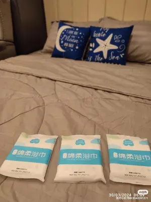a bed with two packages of milk on it at Lenggong GEM 16 Homestay in Kampong Ulu Jepai