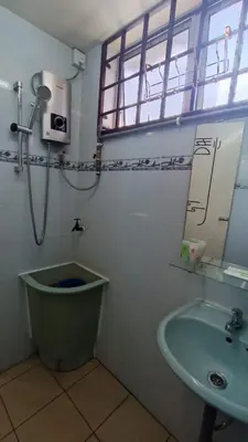 a bathroom with a sink and a toilet and a window at Lenggong GEM 16 Homestay in Kampong Ulu Jepai