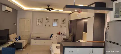 a kitchen and living room with a ceiling fan at Lenggong GEM 16 Homestay in Kampong Ulu Jepai