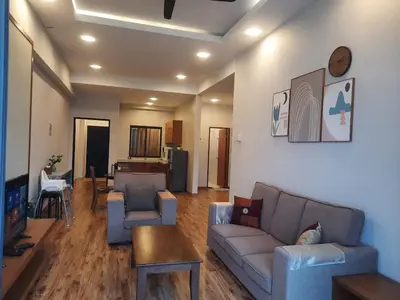 a living room with a couch and a table at Keafarm Highland Breeze in Brinchang
