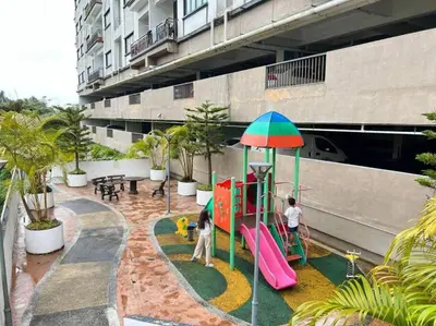 two people playing on a playground in a building at Keafarm Highland Breeze in Brinchang