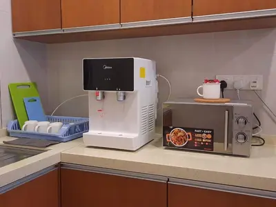 a kitchen counter with a coffee maker and a microwave at Keafarm Highland Breeze in Brinchang