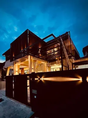 a large building with a fire escape in front of it at New Grand Muji Style Villa at Central Penang 16pax in Bukit Lada