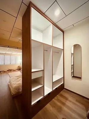 a bedroom with white shelves and a bed in it at New Grand Muji Style Villa at Central Penang 16pax in Bukit Lada