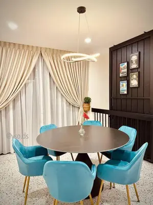 a dining room with a table and blue chairs at New Grand Muji Style Villa at Central Penang 16pax in Bukit Lada
