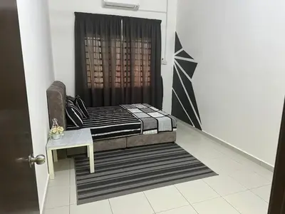 a living room with a couch and a shower at SakuZa Homestay in Slim River