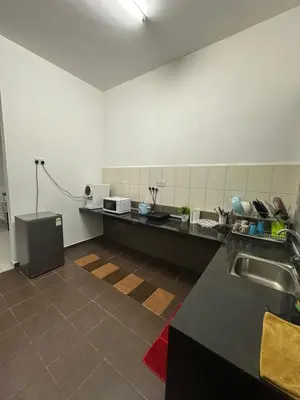 a kitchen with a sink and a counter top at SakuZa Homestay in Slim River