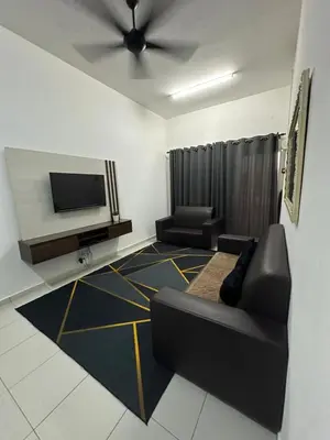 a living room with a couch and a flat screen tv at SakuZa Homestay in Slim River