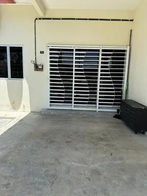 a garage with a garage door with a gate at SakuZa Homestay in Slim River