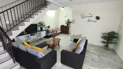 a living room with two couches and a staircase at 77 homestay 5Min to Leaning Tower in Teluk Intan