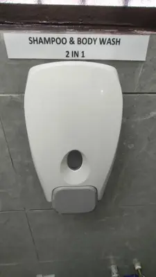 a white toilet sitting on the floor in a bathroom at 77 homestay 5Min to Leaning Tower in Teluk Intan