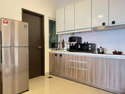 a kitchen with a stainless steel refrigerator and cabinets at G Home 1 - Ipoh City Center Majestic 2R2B in Ipoh