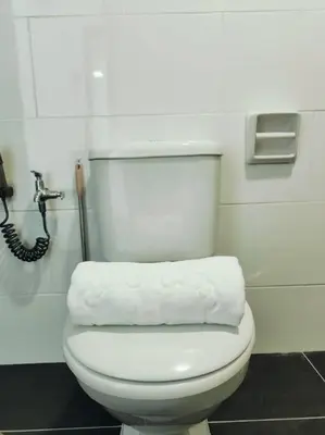 a white toilet in a bathroom with a phone at G Home 1 - Ipoh City Center Majestic 2R2B in Ipoh