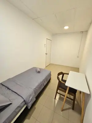 a room with a bed and a table and a chair at SS TWO Hostel Penang in George Town