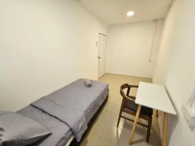 a room with a bed and a table and a chair at SS TWO Hostel Penang in George Town