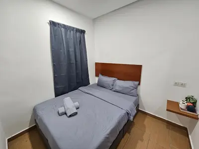 a bedroom with a bed with two towels on it at New Mawlaya Hotel Penang in Gelugor