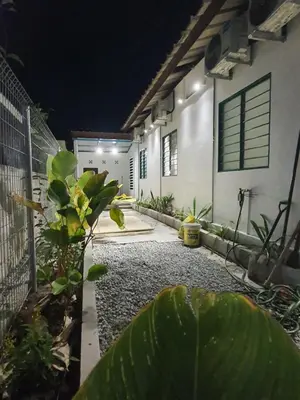 a courtyard of a house at night at Stay Meow Meow Mount Erskine Near Gurney Plaza, Adventist in George Town