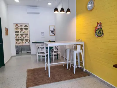 a dining room with a white table and chairs at Stay Meow Meow Mount Erskine Near Gurney Plaza, Adventist in George Town