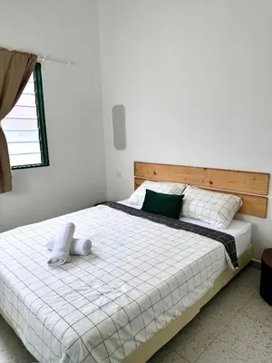 a bedroom with a large white bed with a pillow on it at Stay Meow Meow Mount Erskine Near Gurney Plaza, Adventist in George Town