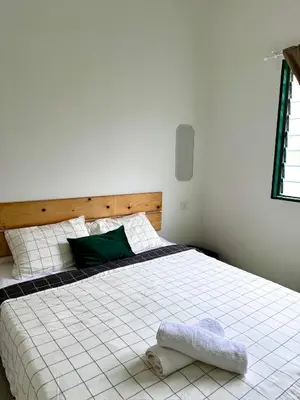 a bedroom with a white bed with a towel on it at Stay Meow Meow Mount Erskine Near Gurney Plaza, Adventist in George Town