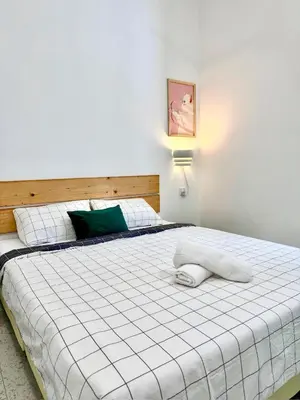 a bedroom with a large white bed and a light at Stay Meow Meow Mount Erskine Near Gurney Plaza, Adventist in George Town