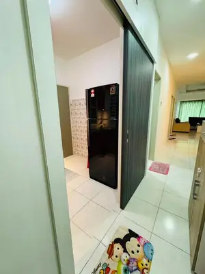 a hallway with a black refrigerator in a room at AYAAN DELUXE HOMESTAY FREE WiFi in Cameron Highlands