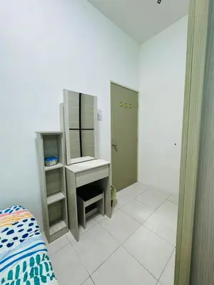a bedroom with a desk and a mirror and a bed at AYAAN DELUXE HOMESTAY FREE WiFi in Cameron Highlands