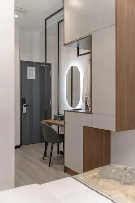 a bedroom with a desk and a mirror at Saturn Hotel in George Town