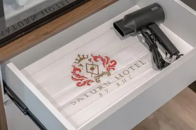 a table with a sign in a white drawer at Saturn Hotel in George Town