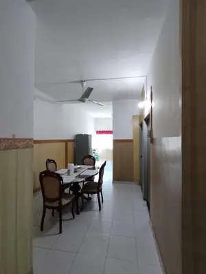 a dining room with a table and chairs at Homestay NAQ D' Kuala Kangsar in Kuala Kangsar