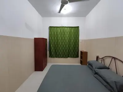a bedroom with a bed and a green window at Homestay NAQ D' Kuala Kangsar in Kuala Kangsar