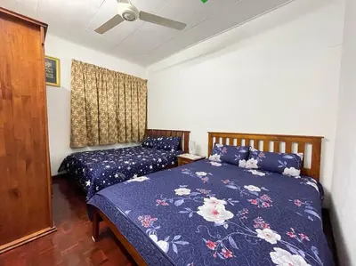 a bedroom with two beds and a ceiling fan at 4BR 2Storey Terrace Homestay at Bukit Jambul by SK Vacation Homes in Bayan Lepas