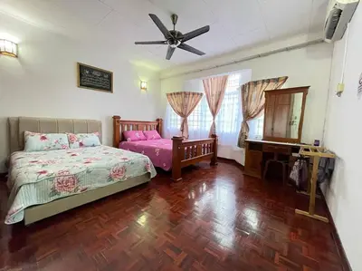 a bedroom with a bed and a mirror and a fan at 4BR 2Storey Terrace Homestay at Bukit Jambul by SK Vacation Homes in Bayan Lepas