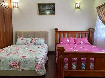 a bedroom with two beds with pink sheets at 4BR 2Storey Terrace Homestay at Bukit Jambul by SK Vacation Homes in Bayan Lepas